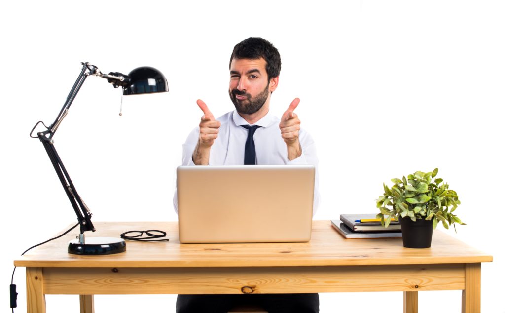 Businessman in his office pointing to the front